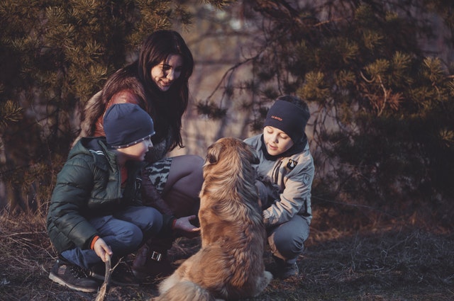 A mother with her children and her emotional support dog enjoying the outdoors